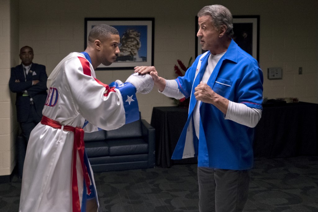 Michael B. Jordan, left, and Sylvester Stallone in a scene from "Creed II." The Rocky spinoff placed second with $35.3 million from the weekend and $55.8 million since Wednesday.