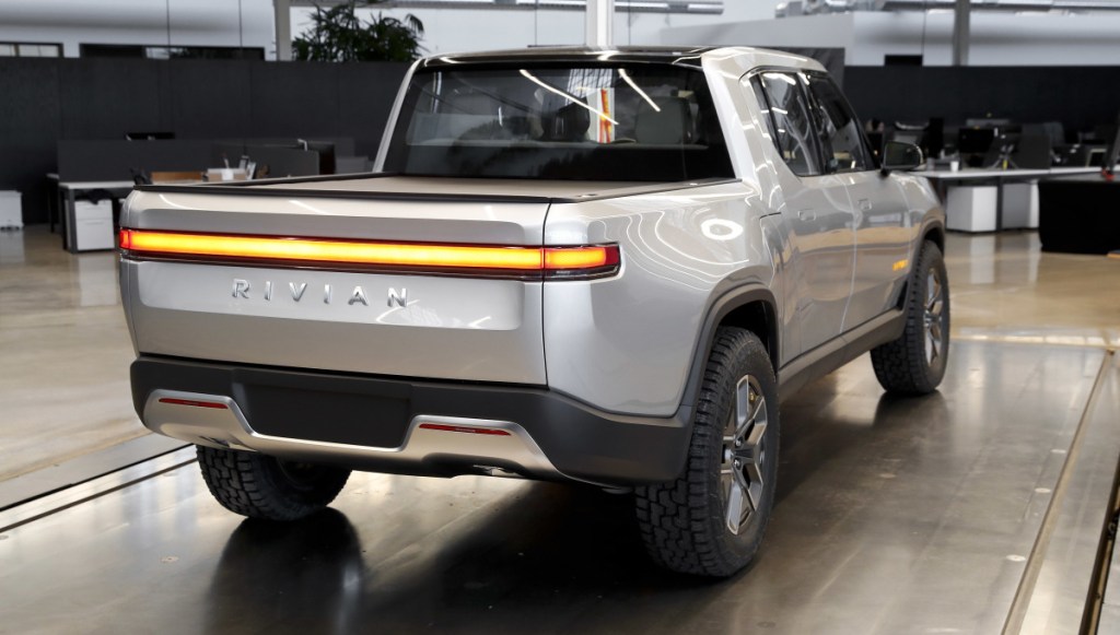 Rivian says the top version of its R1T pickup, above, will have more than 400 miles of battery range per charge. The five-seat, off-road-capable truck is aimed at a market that Tesla is not yet in.