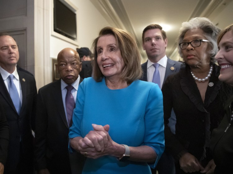 House Democratic Leader Nancy Pelosi of California, joined at left by Rep. John Lewis, D-Ga., and Rep. Eric Swalwell, D-Calif., right, emerges victorious from the Democratic Caucus leadership elections, as her party takes the majority in the new Congress in January, at the Capitol in Washington, Wednesday, Nov. 28, 2018. Associated Press/J. Scott Applewhite