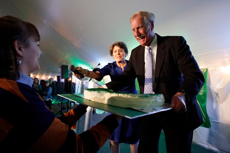 U.S. Sen. Angus King reacts as he is presented with a mustache-shaped cake shortly before announcing his re-election over candidates Eric Brakey and Zak Ringelstein on election night at Flight Deck Brewery in Brunswick. 