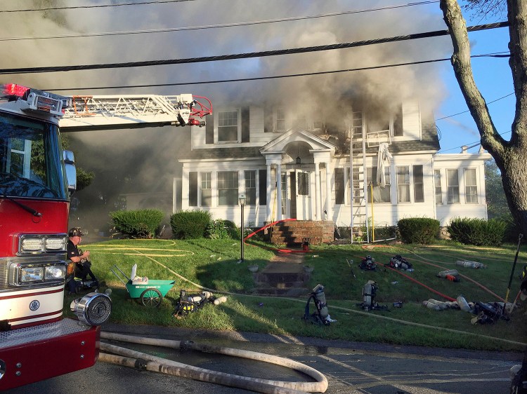 Firefighters battle a house fire on Thursday on Herrick Road in North Andover, Mass., one of multiple emergency crews responding to a series of gas explosions and fires triggered by a problem with a gas line that feeds homes in several communities north of Boston. 