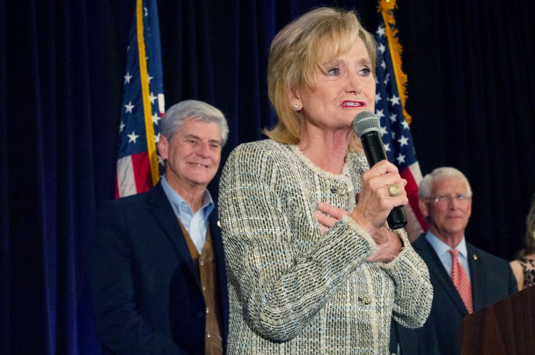 Sen. Cindy Hyde-Smith, R-Miss., speaks to supporters of her campaign during an election night party she shared with fellow Republican U.S. Sen. Roger Wicker, right, in Jackson, Miss., Tuesday, Nov. 6, 2018. Hyde-Smith, who was appointed to the seat, is in a Nov. 27 runoff against Mike Espy in this non-partisan race. The winner will serve the last two years of the six-year term vacated when Republican Thad Cochran retired for health reasons.