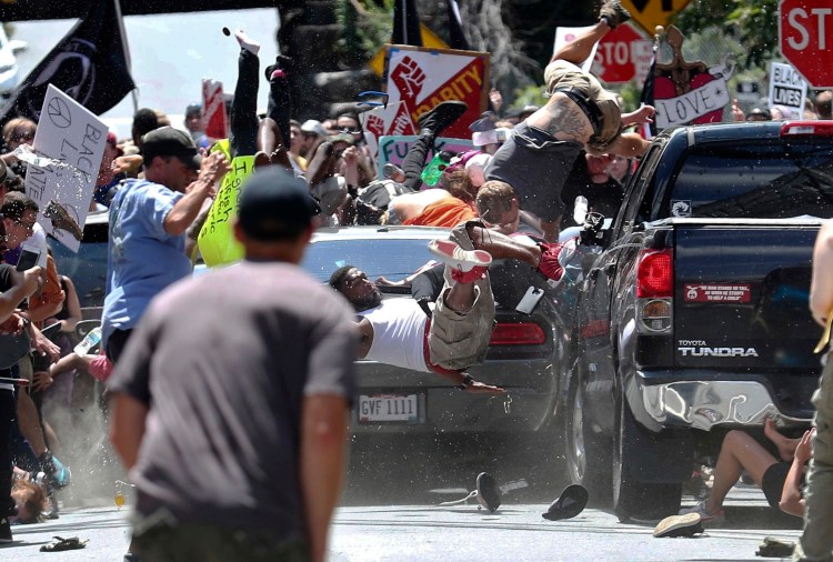 People fly into the air on Aug. 12, 2017, as a vehicle is driven into a group of protesters demonstrating against a white nationalist rally in Charlottesville, Va. James Alex Fields Jr. is accused of driving into the crowd demonstrating against a white nationalist protest, killing one person and injuring many more.