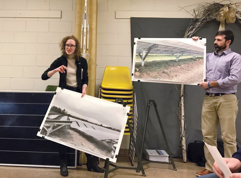 Liz Peyton and Jonathan Gravel, project managers for NextEra, present images of the company's Coolidge Solar Project in Vermont, to members of the Farmington Planning Board to illustrate what a proposed 77-megawatt project would look like. Officials with NextEra also brought a sample solar panel, pictured behind Peyton, to demonstrate what the panels used in the project would look like.