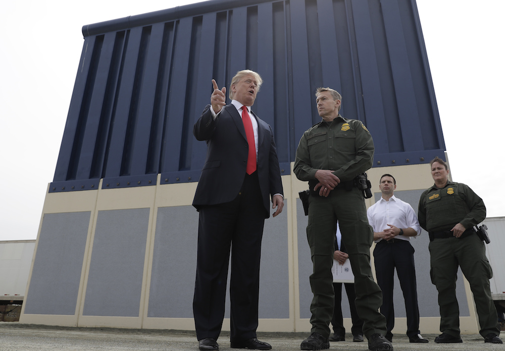President Donald Trump in front of a border wall prototypes in San Diego in March
