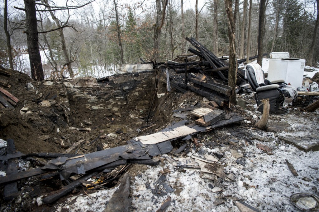A chair and some appliances are all that remain at an abandoned house was destroyed by fire early Saturday morning on North Avenue in Skowhegan. Authorities had to excavate the remnants of the house. It is the property where law enforcement earlier this year searched for Tina Stadig, who remains missing.