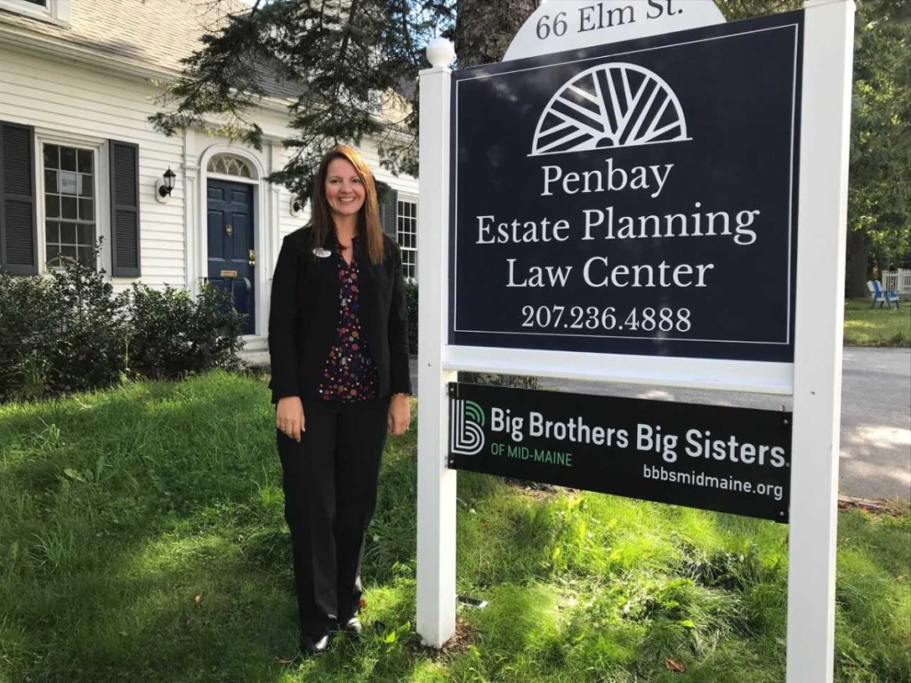 Gwendolyn Hudson, executive director of Big Brothers Big Sisters of Mid-Maine, stands near a newly installed sign outside the agency's Camden office.