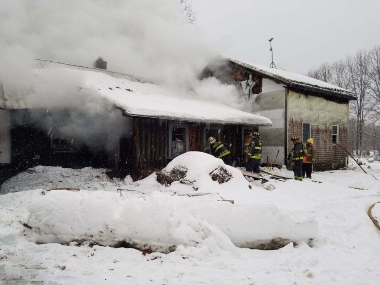 Firefighters battle a blaze that destroyed a home early Sunday on Pease Hill Road in Anson.