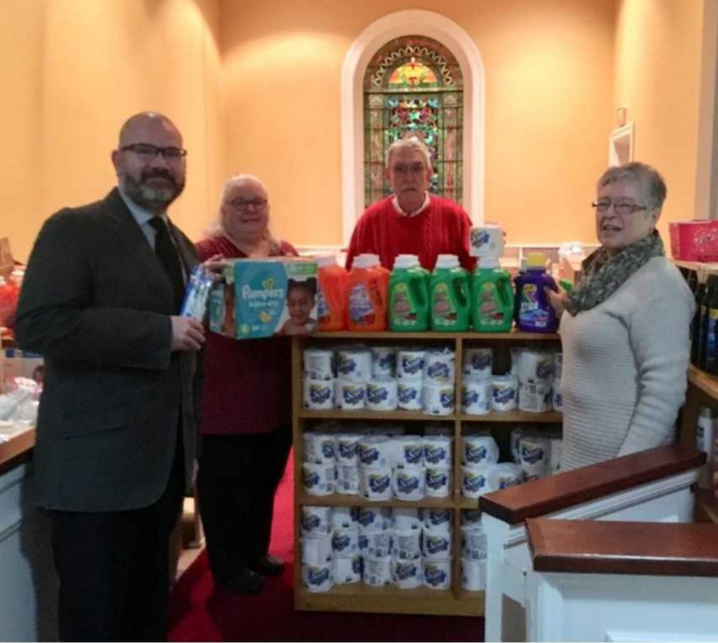 Mark Wilson, pastor, left, with Gail Morris, Carl Daiker and Lora Downing organize items and volunteer in the Essentials Closet located at the First Congregational Church, Eustis Parkway in Waterville.