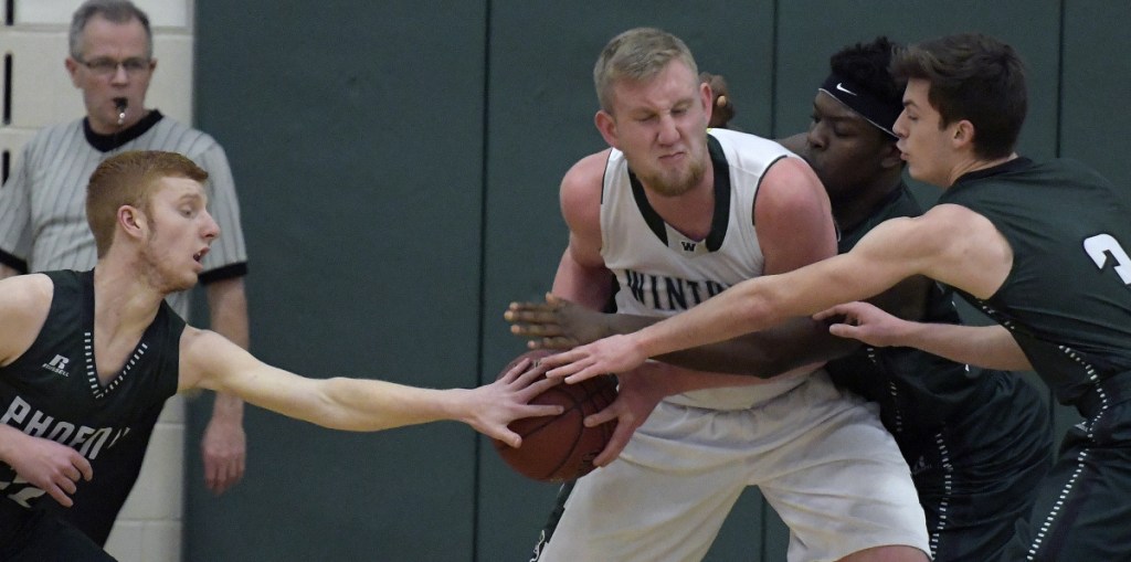 Winthrop's Cam Wood draws a crowd of Spruce Mountain defenders during a Mountain Valley Conference game last season in Winthrop. Wood and the Ramblers look to contend in the MVC this winter as well.