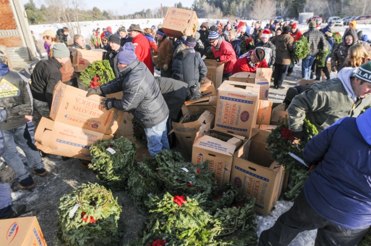 Volunteers unload wreaths Dec. 16, 2017, at the start of the first of three Wreaths Across America events, at the Maine Veterans Memorial Cemetery on Mount Vernon Road in Augusta. On Sunday, a convoy of trucks carrying Maine-made wreaths to Arlington National Cemetery as part of the ceremonies will stop in Augusta for a rally to show appreciation for veterans.