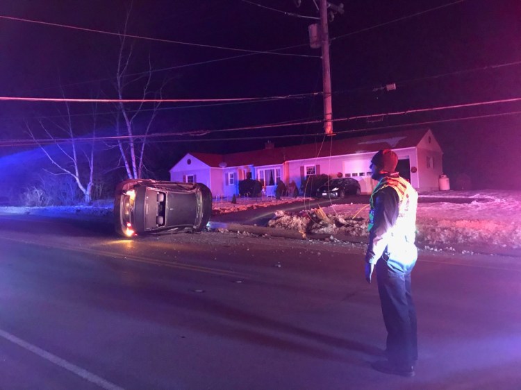Waterville police and firefighters arrived at the scene Friday evening on Main Street after a car struck a telephone pole and rolled over.