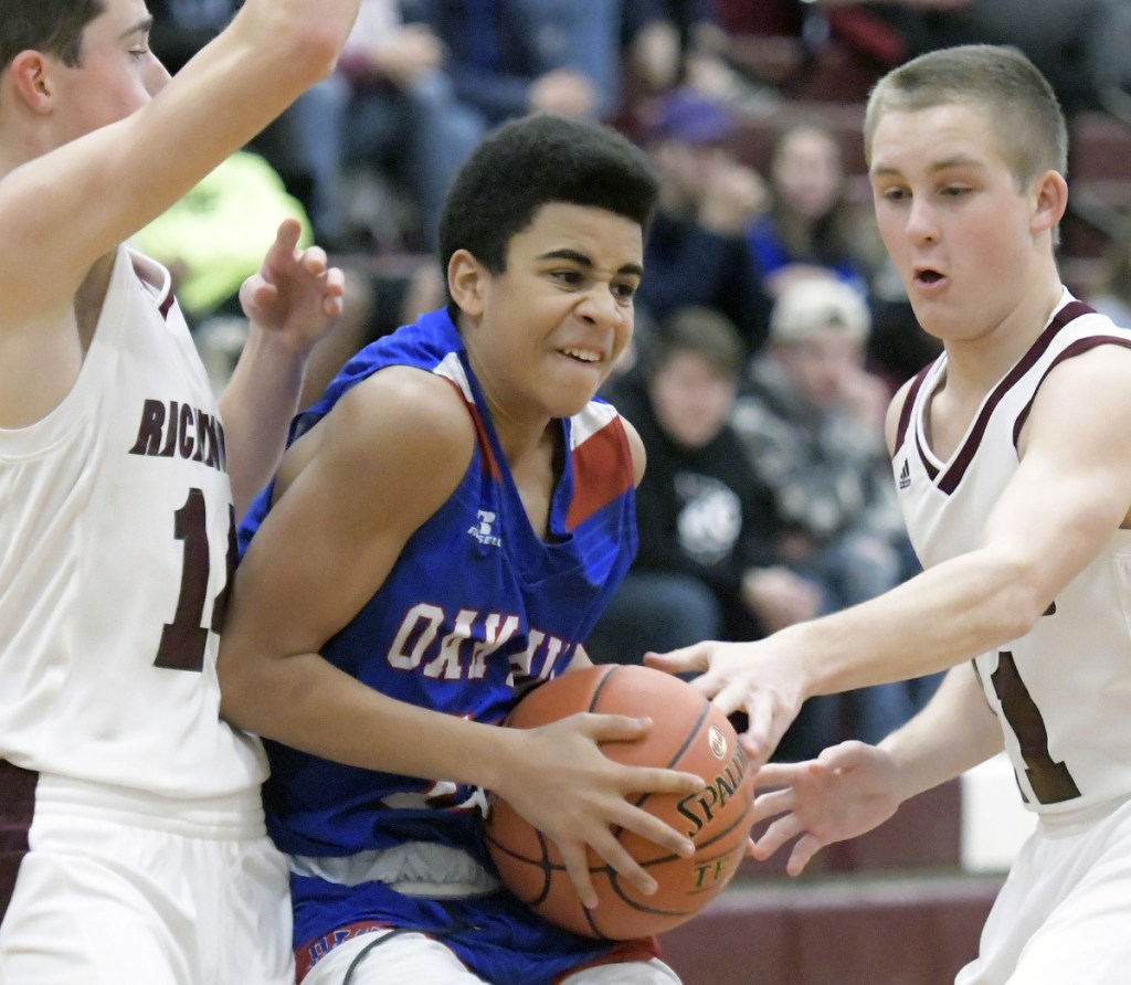 Richmond's Dakotah Gilpatric, left, and Ben Gardner play defense on Oak Hill's Ausborne Boston during a Mountain Valley Conference game Wednesday in Richmond.