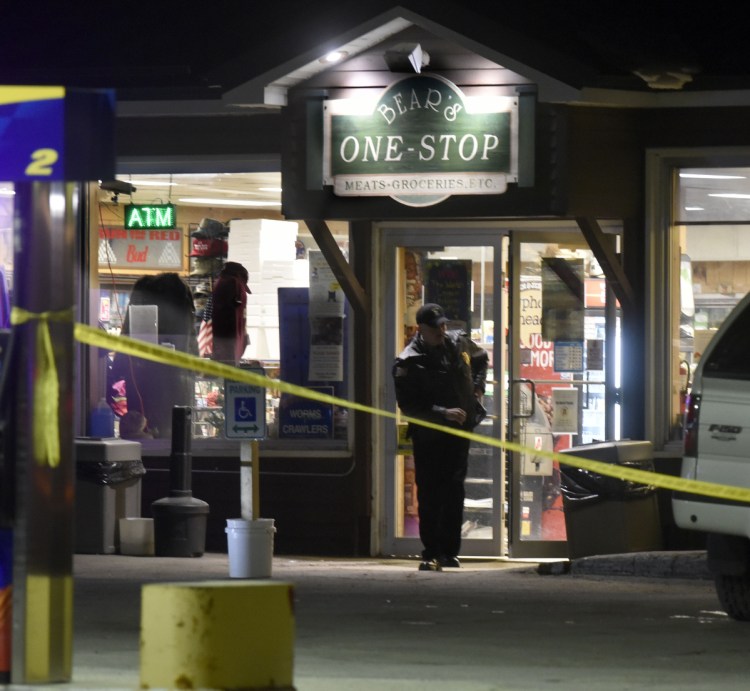A police officer exits the Bear's One Stop store in Newport as other investigators inside speak with employees following a shooting early Wednesday evening.