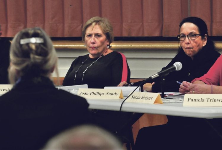 Waterville school board member Susan Reisert, right, takes part on Nov. 16, 2015, in a dismissal hearing about then-Waterville Senior High School Principal Don Reiter. Reisert has announced that she has  resigning from her board seat. Also pictured, Attorney Melissa Hewey, facing away, speaks with attorney Bryan Dench. Sitting with Dench, from left, are Waterville Board of Education Chairman Sara Sylvester and member Joan Phillips-Sandy.