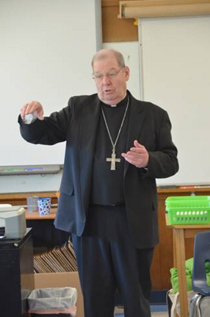 Bishop Robert P. Deeley speaks with students Monday, Dec. 10, at St. Michael School in Augusta.