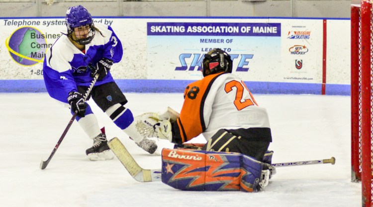 Winslow/Gardiner/Cony goalie Gabriella Chambers blocks a shot by Lewiston's Paige Pomerlea, left, during a game earlier this season at the Camden National Bank Ice Vault in Hallowell. Winslow/Gardiner will play Yarmouth/Freeport in the regional quarterfinals on Wednesday.