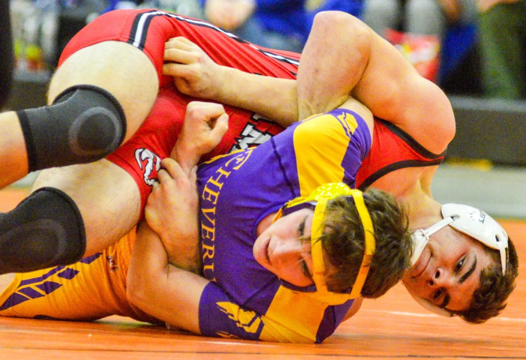 Cony's Nic Mills wrestles Cheverus' Sebastian Merrill in the 195-pound semifinals Saturday in Gardiner.