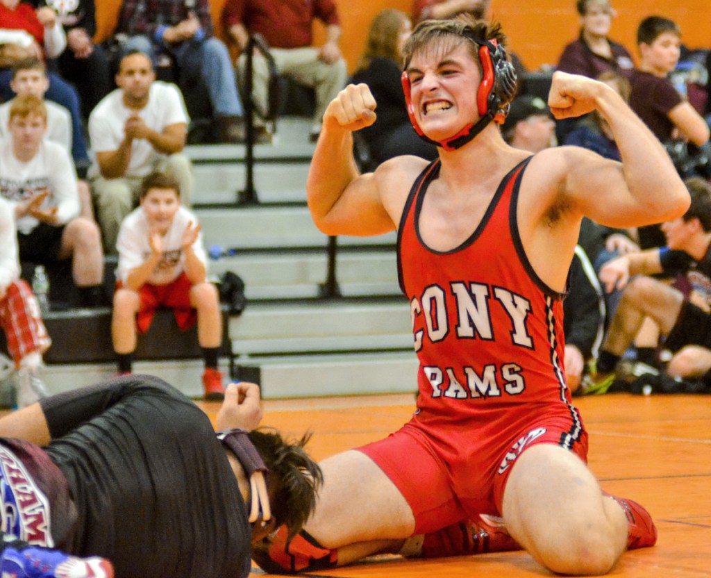 Cony's Jakob Arbour celebrates after pinning Windham's George Butts in the 152-pound match Saturday in Gardiner.