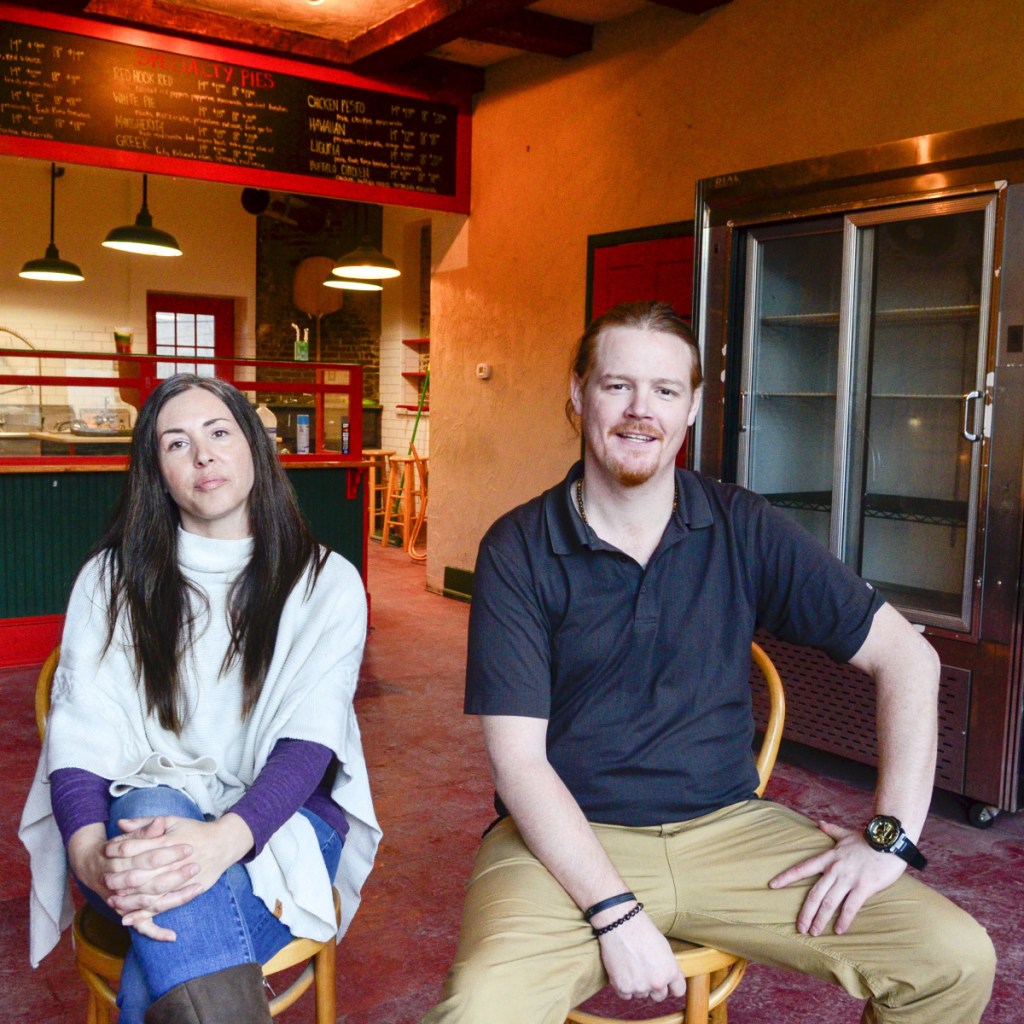 Allison Michaud, left, and Brian King sit in the former Kennebec Pizza Co. storefront on Thursday in Hallowell. They plan to open a medical marijuana retail store there named The Frost Factory.