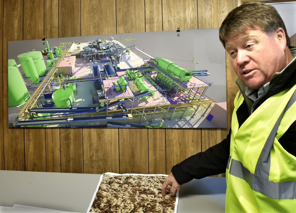 Fiberight Corp. CEO Craig Stuart-Paul shows some cellulose product that can be rendered and sold after being processed at the new solid waste processing and recycling facility under construction in Hampden on Thursday.