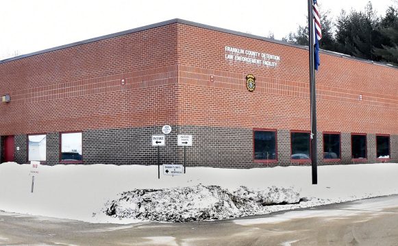 A cruiser exits the Franklin County Jail in Farmington beside the sheriff's office Tuesday. Town and county officials are discussing what they say is a lack for funding for the jail.