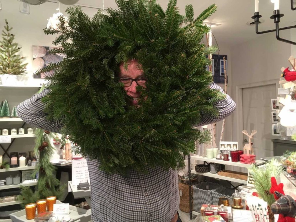BIRCH Home Furnishings and Gifts co-owner Brad Sevaldson jumps right in when presented with his bare wreath ready for decorating as part of Wiscasset Holiday Marketfest's Wreaths Around the Holidays. Wreaths were on display in the Nickels-Sortwell barn Dec. 7-9.