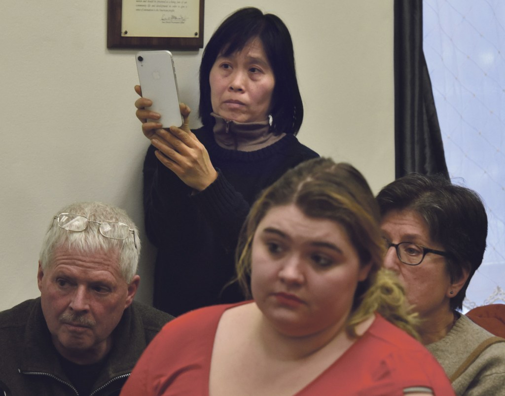 Sally Kwan records Somerset County Commissioners regarding CMP's New England Clean Energy Connect project during a meeting in Skowhegan on Wednesday. Kwan opposes the project.