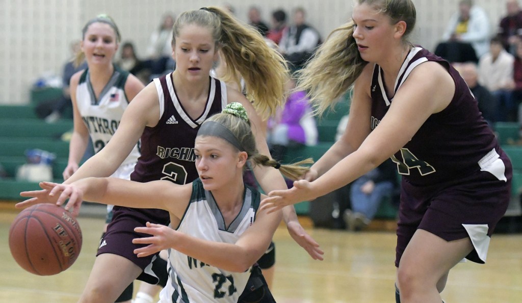 Winthrop's Layne Audet, center, passes beneath Richmond's defense during a Mountain Valley Conference game Wednesday in Winthrop.