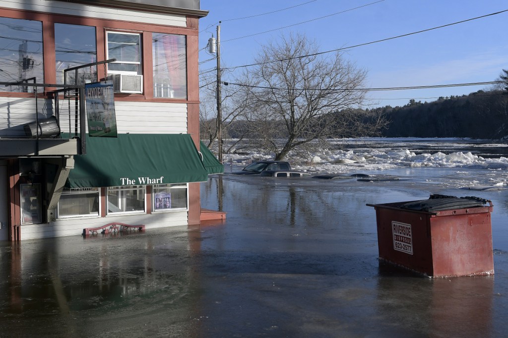 Cars stand submerged Jan. 14 in the Kennebec River in Hallowell after flooding in the early morning.