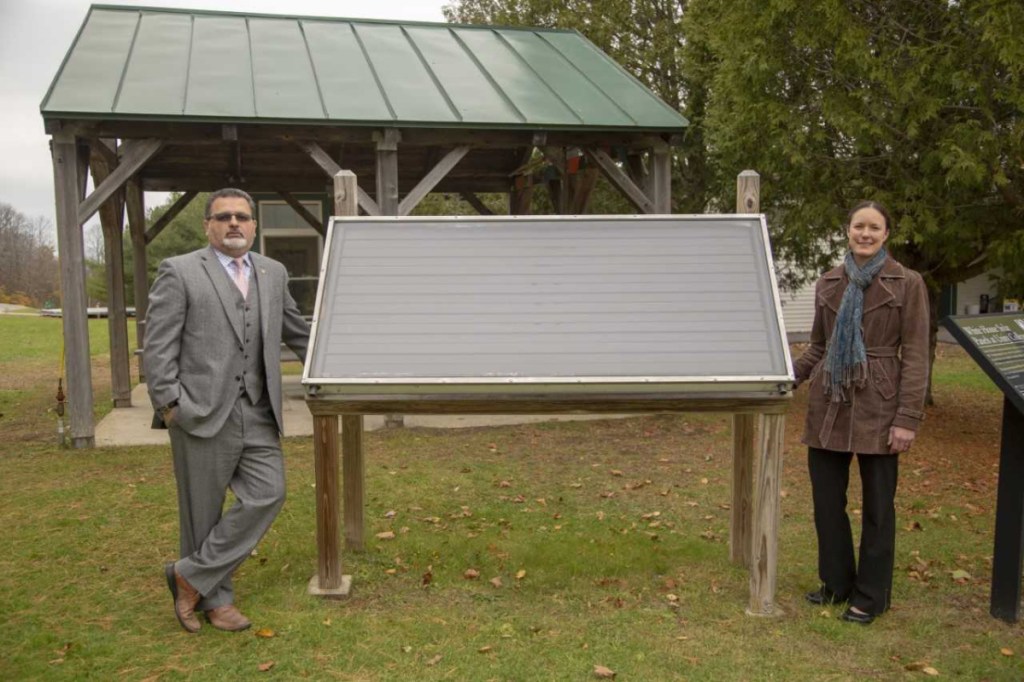 Unity College President Dr. Melik Peter Khoury, left, and Chief Sustainability Officer Jennifer deHart, stand next to one of the College's Jimmy Carter solar panels that the former president placed on the White House during his time in office. Two of the panels are featured in the largest exhibition ever about the Sun at the Science Museum in London.