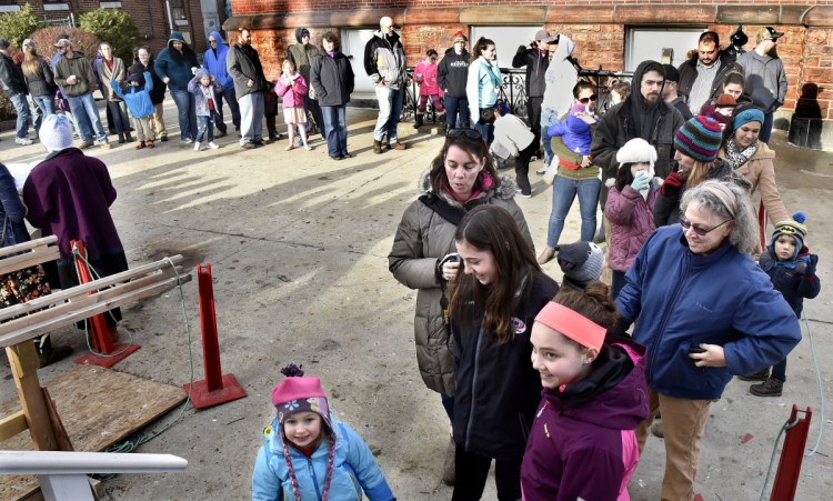 More than 60 parents and children wait in line Dec. 16 to see Santa at Kringleville in Waterville.