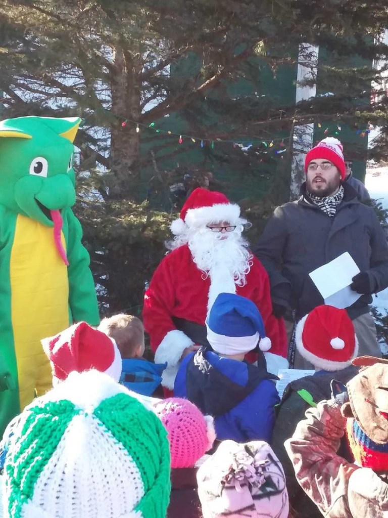 Carrabec Community School staff and students walked to the North Anson Fire Department on Wednesday, Dec. 19, and sang Christmas carols around the Christmas tree. From left is the school's Carrabec Cobra mascot, Santa Claus and Music Teacher Mr. Dan Gilbert.
