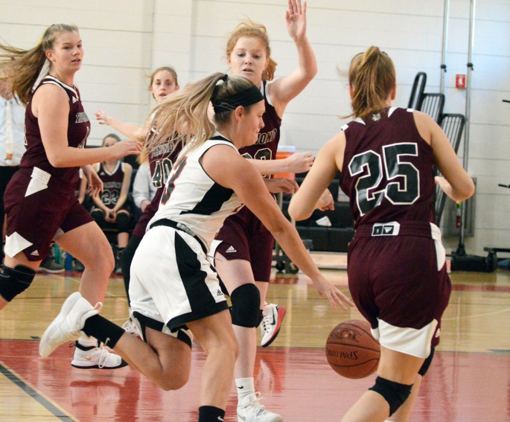 Times Record photo by Bob Conn 
 Lisbon's Mallory Fairbanks (3) tries to dribble between Richmond defenders Bryanne Lancaster (20) and Caitlin Kendrick (25) in Saturday's MVC game Saturday at Lisbon.