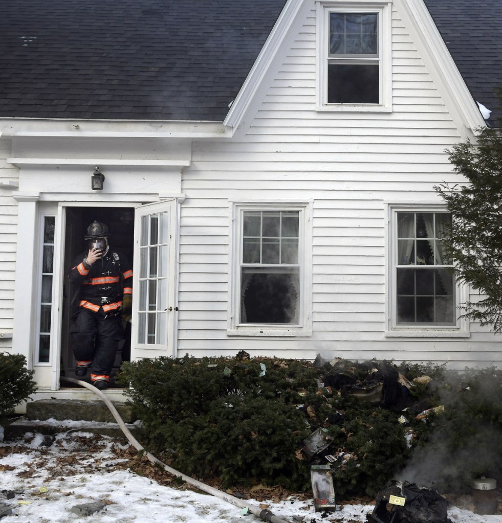 Firefighters extinguish a blaze Monday morning on Neck Road in West Gardiner. Firefighters returned to the farmhouse to discover a fire on the second floor after battling a chimney fire at the residence the night before.