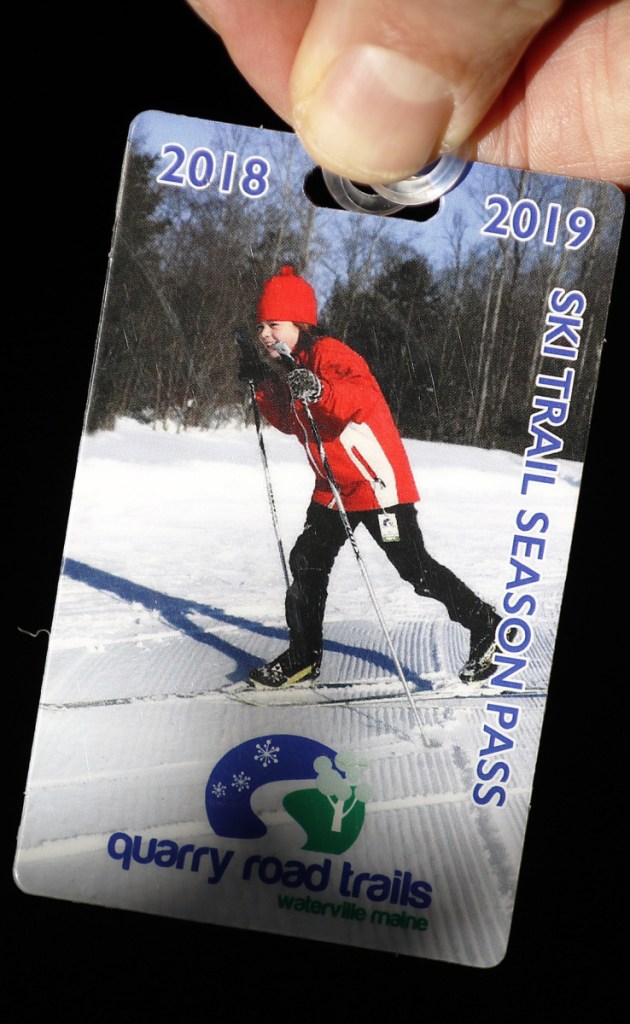 Left: Thomas Klepach, a volunteer at Quarry Hill Trails, shows his season pass for the ski trails.
Below: Rosalea Kimball of Readfield skates uphill at Quarry Road Trails.