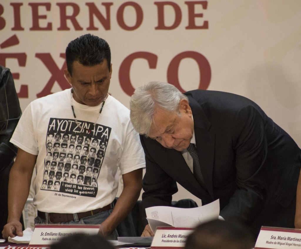 Mexican President Andres Manuel Lopez Obrador signs a decree Monday creating a truth commission to probe the 2014 disappearance of 43 students.
AP Photo/Christian Palma