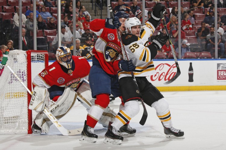 Panthers goalie Roberto Luongo looks for a clear view as defenseman Michael Matheson battles for position with Bruins center Noel Acciari during the second period of Florida's 5-1 win Tuesday in Sunrise, Fla.