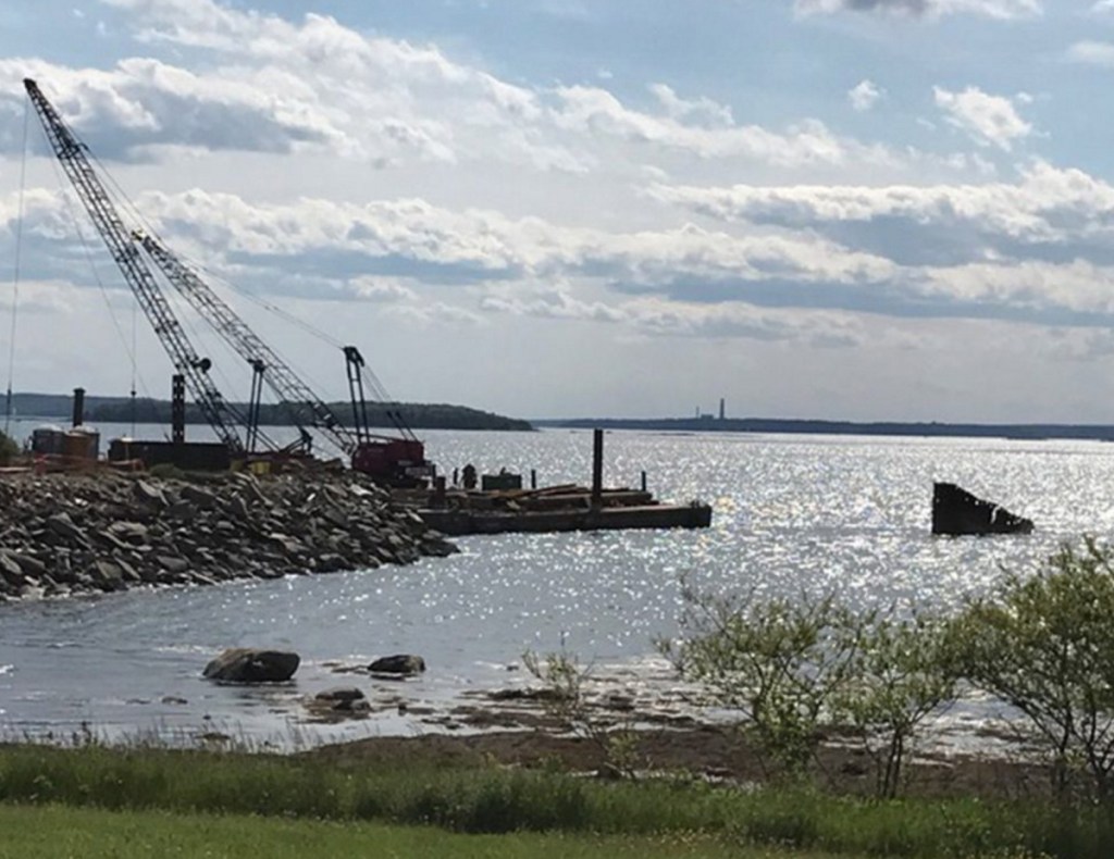 Workers from Reed & Reed remove the old pier at Mitchell Field in Harpswell last June. The 119-acre former fuel depot has been used primarily as recreational land.