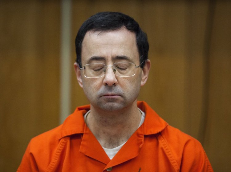 Former USA Gymnastics doctor Larry Nassar listens during his sentencing in Charlotte, Mich., last February. Over 350 athletes have accused Nassar of molesting them.