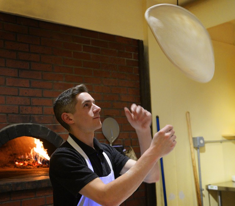 Pizza maker Jay Whitney lets the dough fly at Pizzarino.