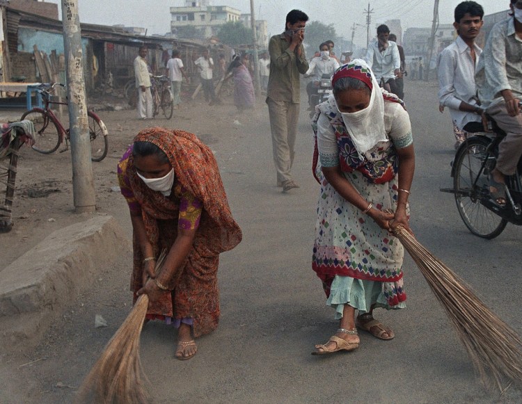 Women in Surat, India, sweep the streets during a plague epidemic in 1994. While rat-associated plague can still be found, it is largely under control.