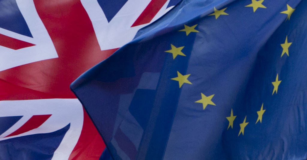 Britain's Union Flag, left, and the EU flag, flap in the wind outside EU headquarters in Brussels on Dec. 8, 2017.