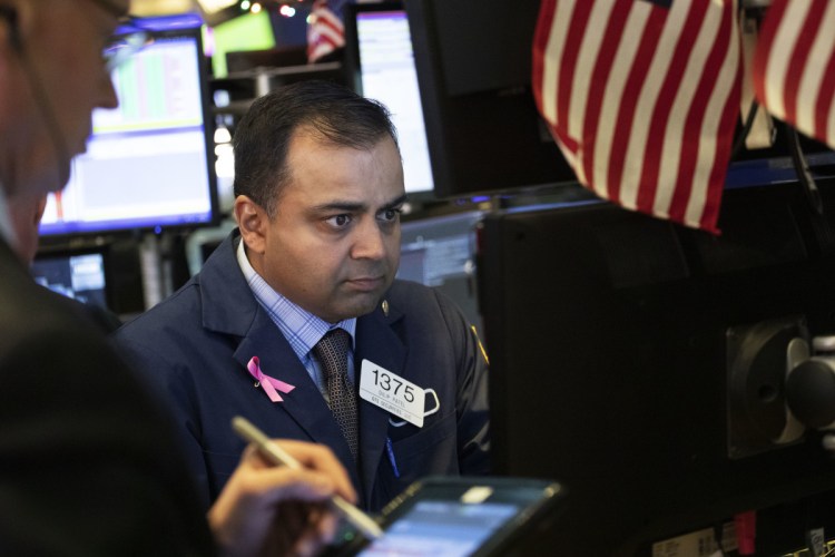 Specialist Dilip Patel works at the New York Stock Exchange on Monday.