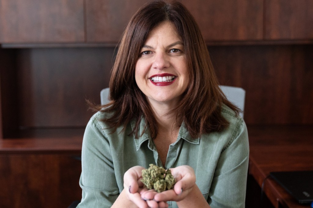 Chris Visco, president and CEO of TerraVida Holistic Center, holds Copper Chem Marijuana Bud by Ilera Healthcare at her office in Abington, Pa. Visco is also a medical marijuana patient, taking it for migraines and insomnia.