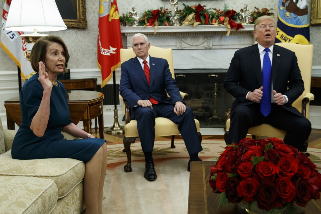 House Minority Leader Rep. Nancy Pelosi, D-Calif., speaks during a meeting with President Trump in the Oval Office of the White House, on Tuesday in Washington. At center is Vice President Mike Pence.