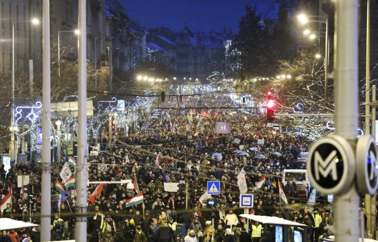 Anti-government demonstrators march under Christmas decorations in the center of Budapest, Hungary, on Sunday. Protesters were demonstrating against recent changes to the nation's labor laws.