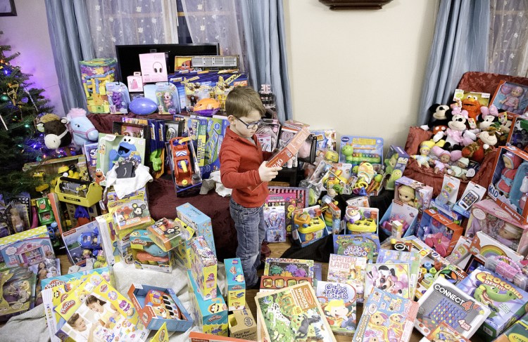 RJ Bourgeois, 6, looks over toys for children at The Barbara Bush Children's Hospital. "We always try to make Christmas all about family and friends," his mother said. "It's not all about presents. It's all about giving."