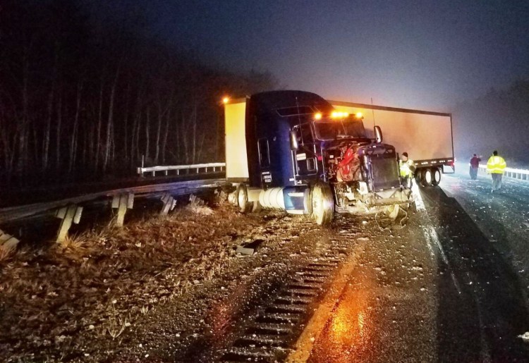 This tractor-trailer truck hit a parked Maine State Police cruiser on the Maine Turnpike early Friday, injuring Trooper John Davis, police said.