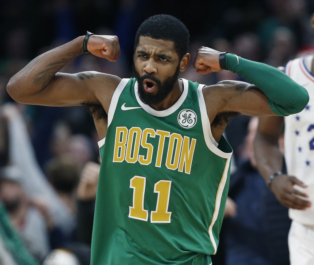 Kyrie Irving celebrates after making a 3-pointer in overtime during Boston's 121-114 win Tuesday against the Philadelphia 76ers. Irving finished with 40 points and 10 rebounds.